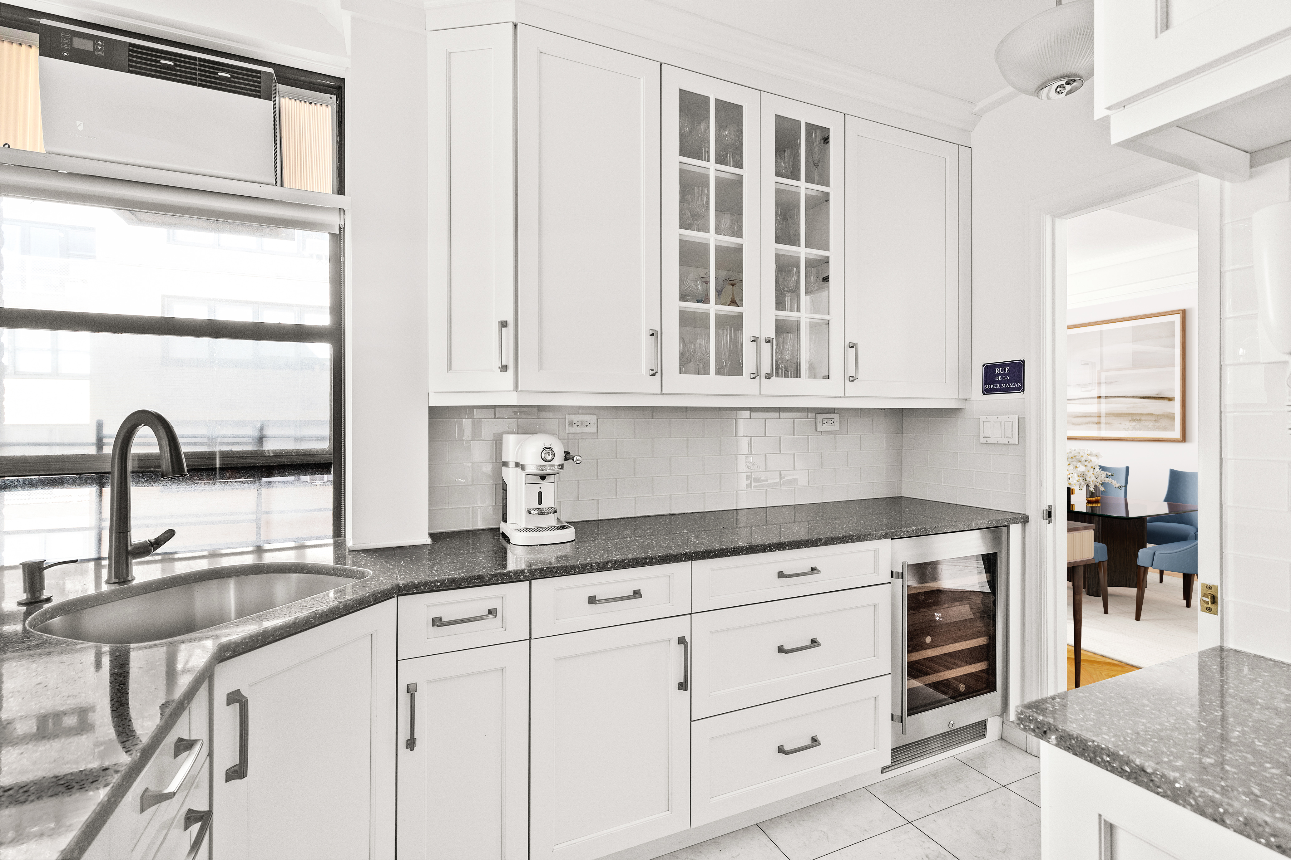 410 East 57th Street, Unit 15B Manhattan, NY 10022 - Photo 6 of 17 a kitchen with granite countertop a stove a sink and a cabinets