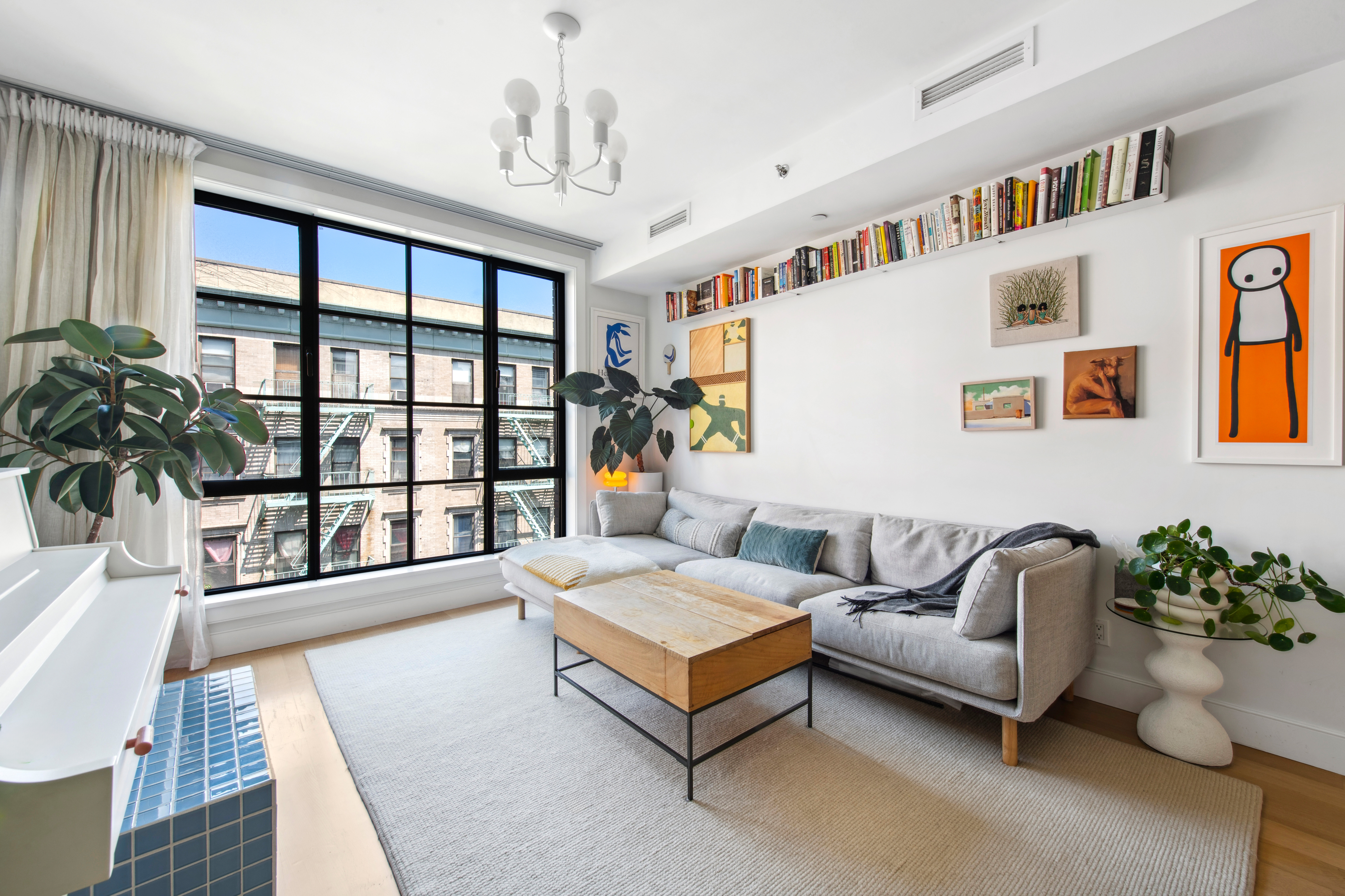 536 East 13th Street, Unit 5F Manhattan, NY 10009 - Photo 3 of 16 a living room with furniture and a large window
