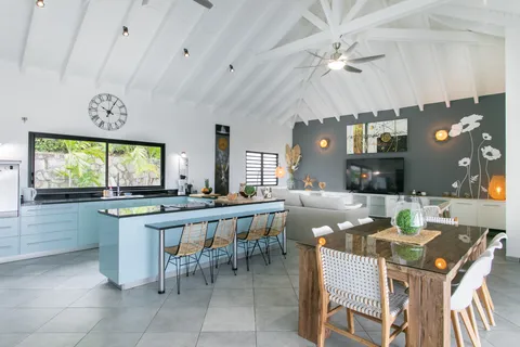 a large kitchen with a table and chairs