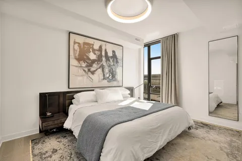 a bedroom with a large bed and a window