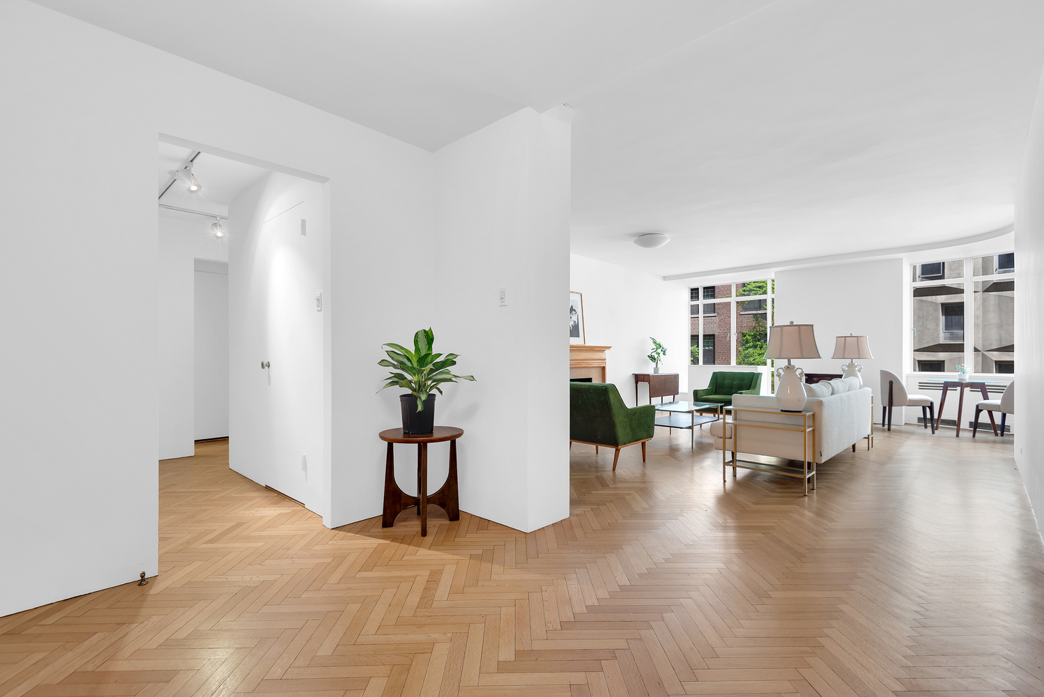 24 West 55th Street, Unit 3D Manhattan, NY 10019 - Photo 3 of 10 a living room with furniture and a potted plant