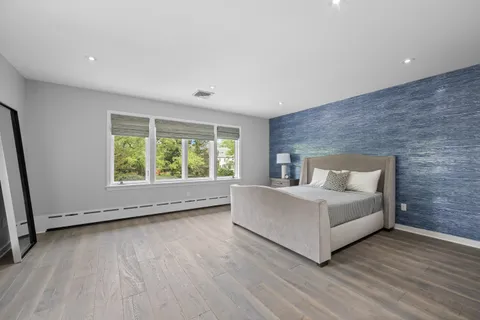 a room with a bed and a large window