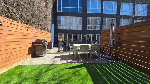 a view of backyard with sitting area