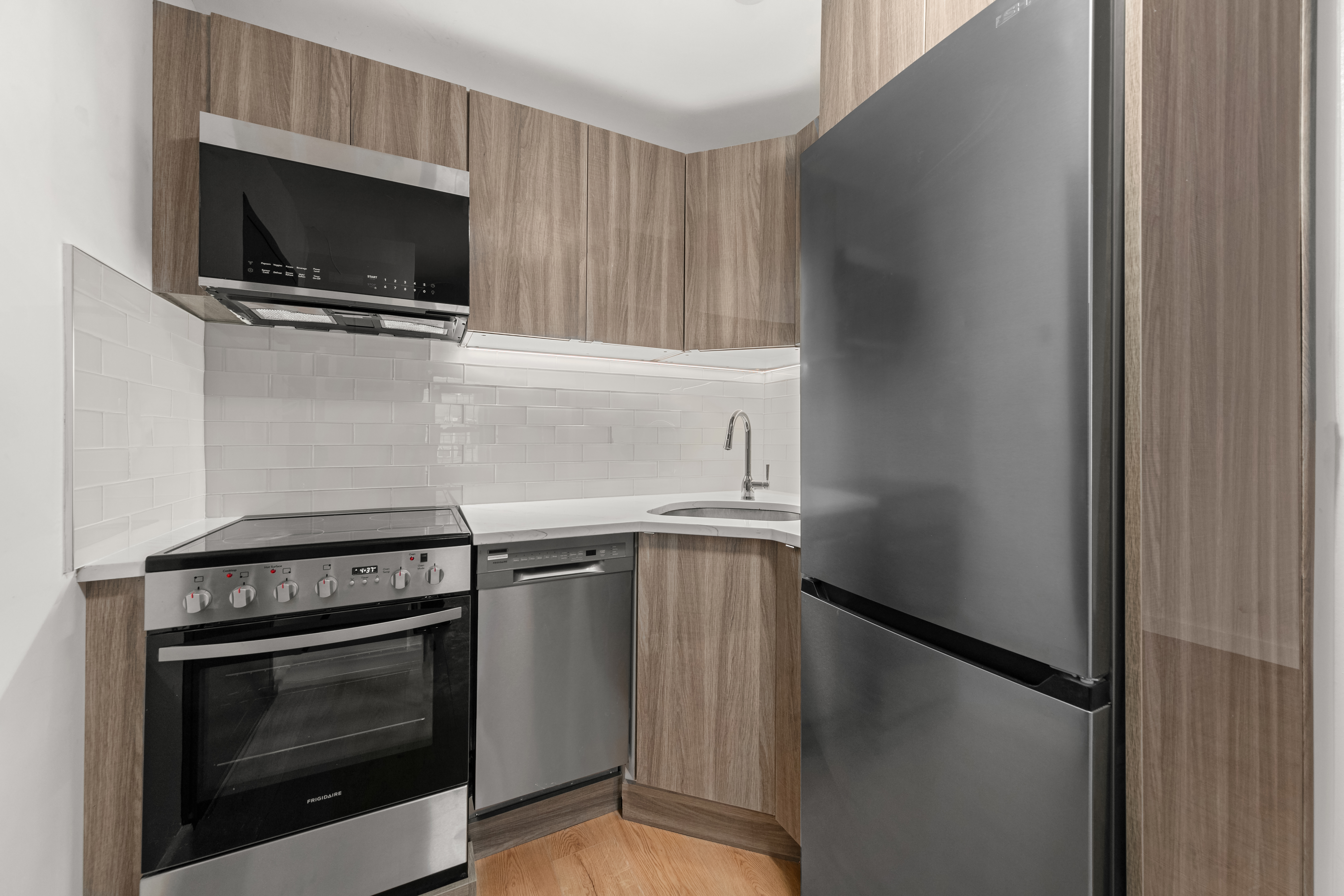227 East 21st Street, Unit 4F Manhattan, NY 10010 - Photo 2 of 6 a kitchen with a stove and a microwave