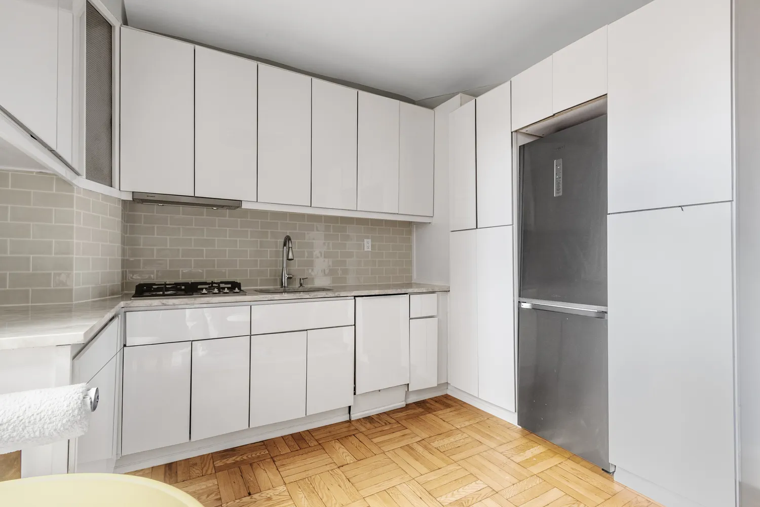 a kitchen with a refrigerator sink and cabinets