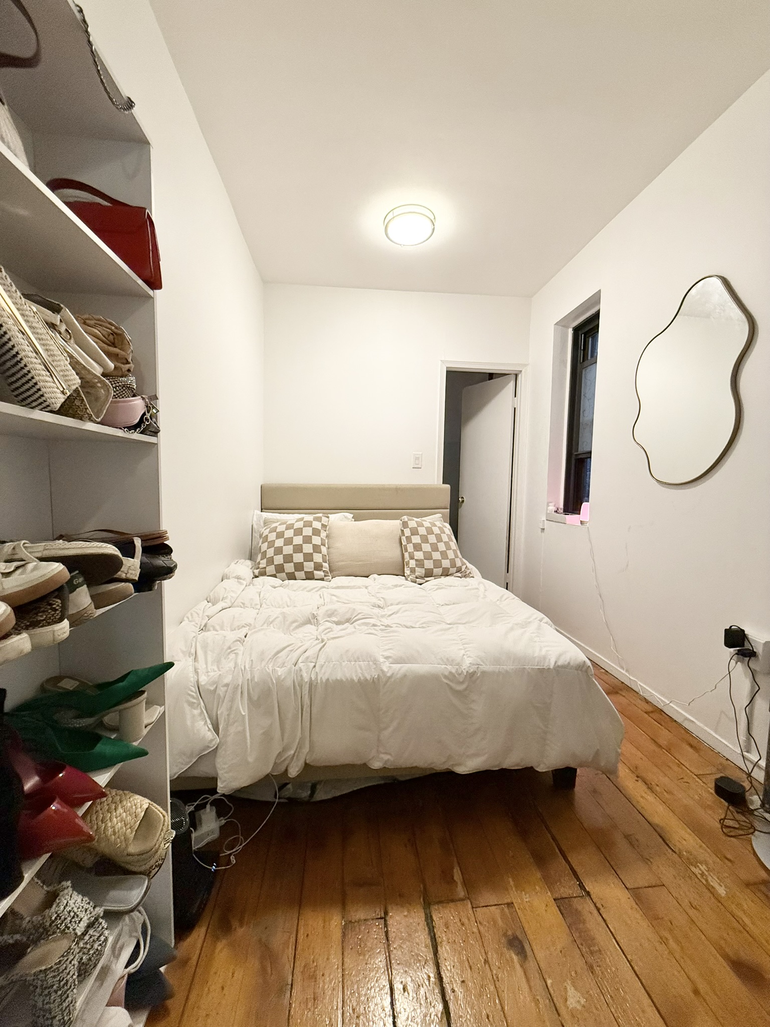 317 East 73rd Street, Unit 3FE Manhattan, NY 10021 - Photo 4 of 6 a bedroom with a bed and wooden floor
