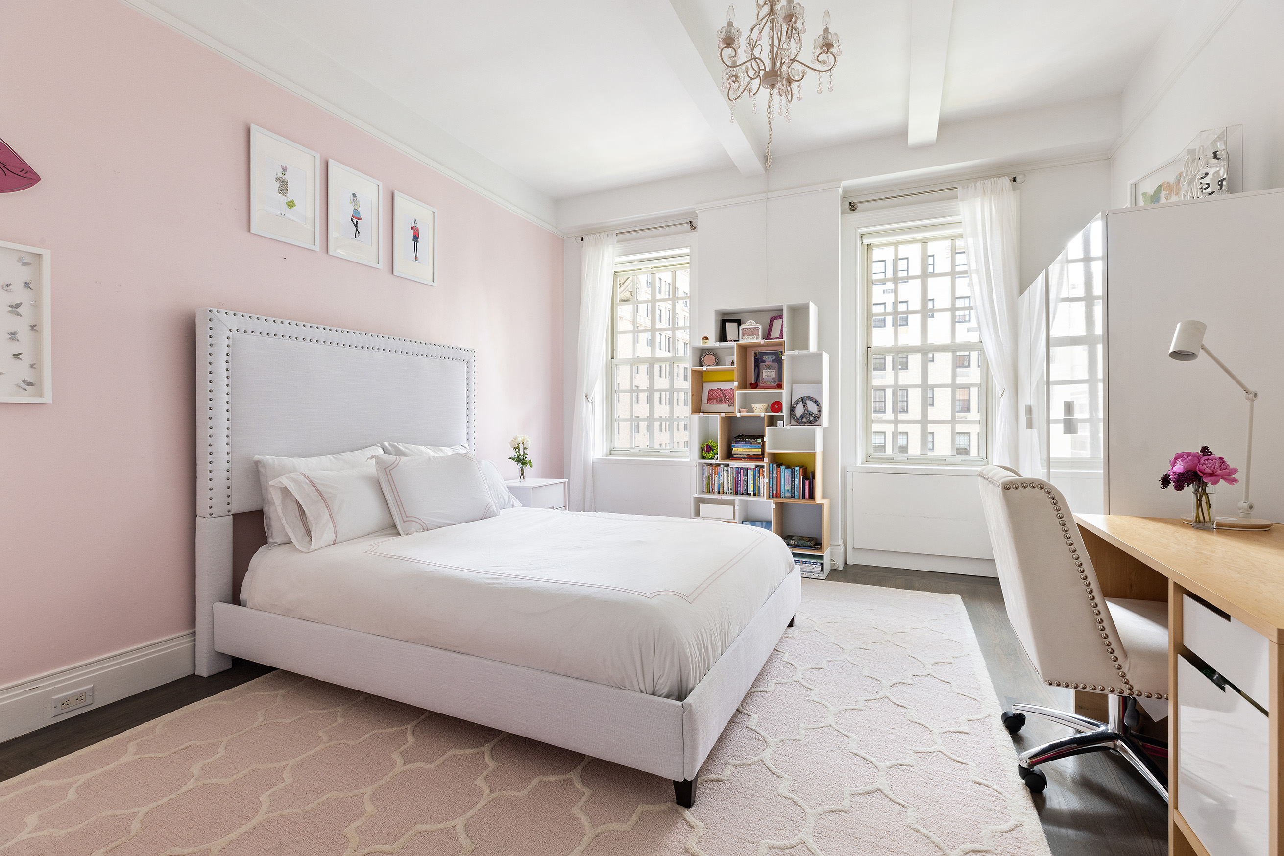 863 Park Avenue, Unit 8W Manhattan, NY 10075 - Photo 8 of 15 a bedroom with a large bed a chandelier and a window