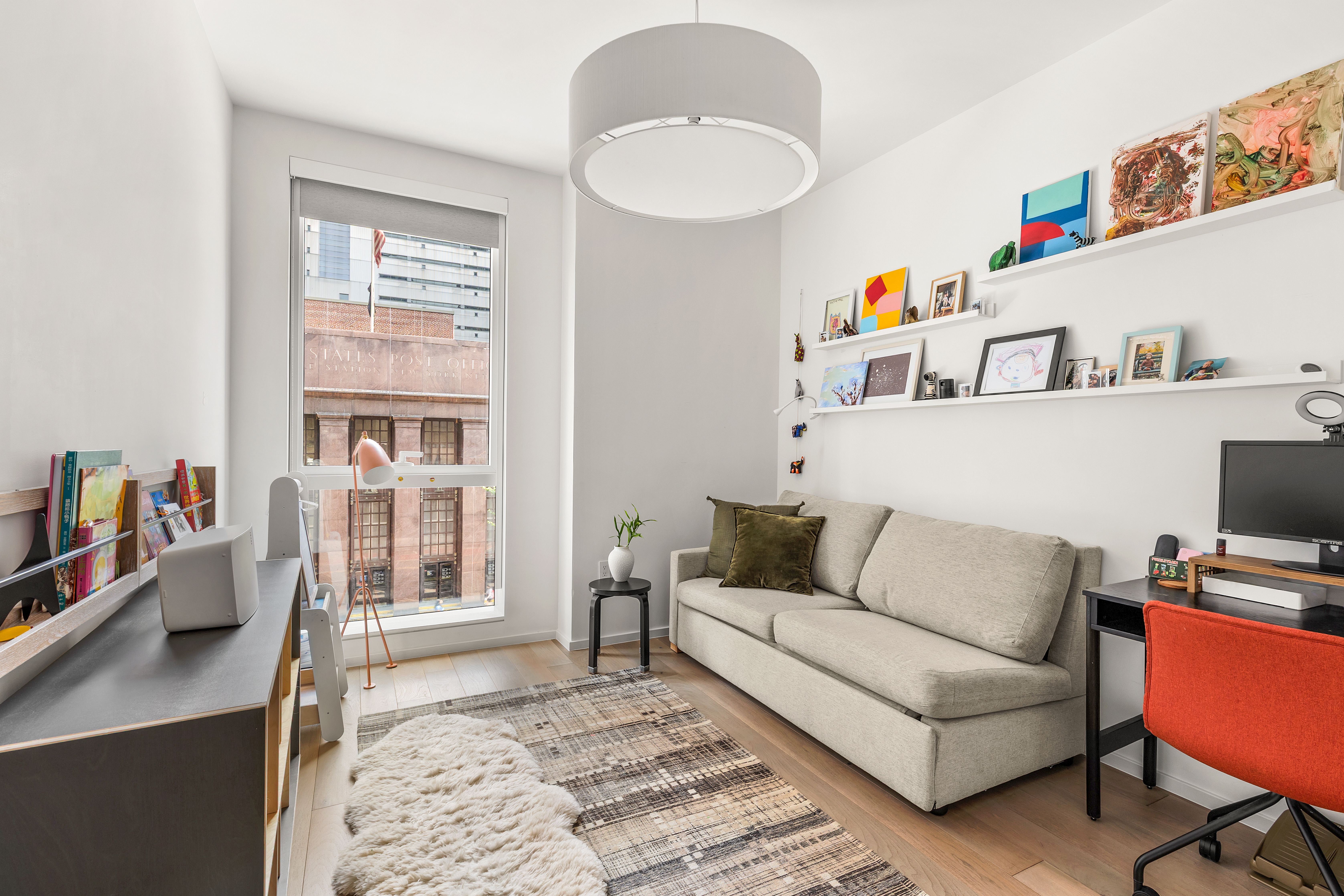 150 East 23rd Street, Unit 3C Manhattan, NY 10010 - Photo 7 of 12 a living room with furniture and a flat screen tv