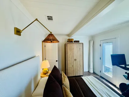 a bed room with a bed and a chandelier