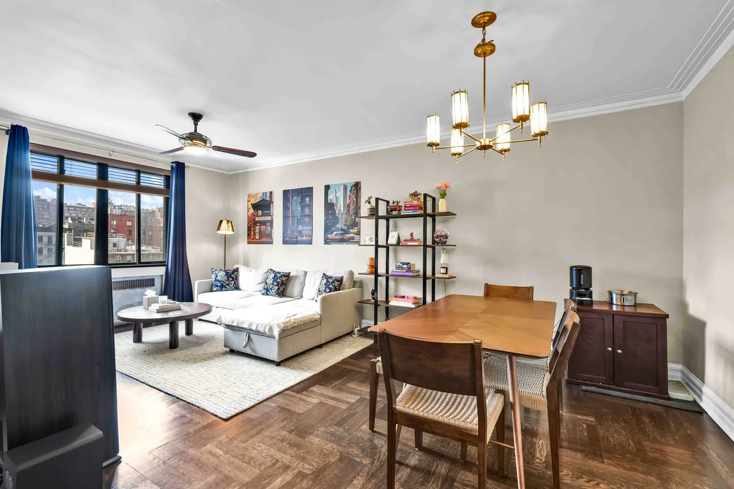 a view of a dining room with furniture a chandelier and wooden floor