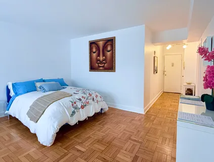 a bedroom with a bed and a couch