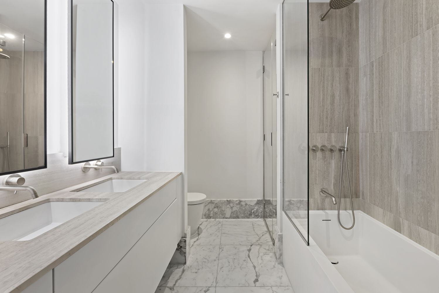 a bathroom with a tub sink and mirror