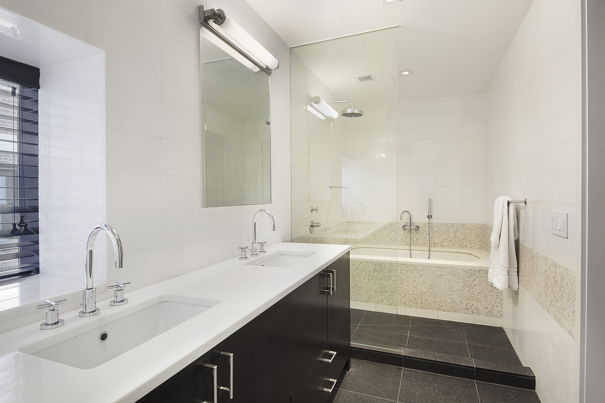441 East 57th Street, Unit 5 Manhattan, NY 10022 - Photo 5 of 7 a bathroom with a double vanity sink mirror and double