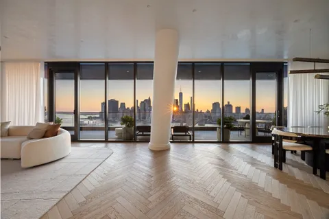 a living room with furniture and large windows