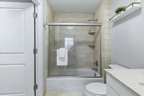 a bathroom with a shower and a toilet