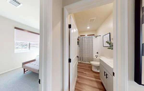 a bathroom with a toilet a sink and a mirror