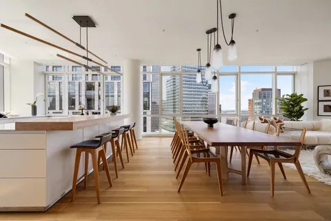 a dining room with furniture window and wooden floor