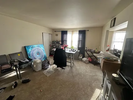a view of a livingroom with furniture and a window