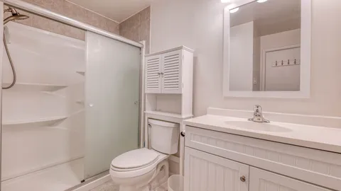 a bathroom with a sink toilet and a mirror