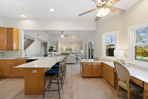 a large kitchen with a table and chairs