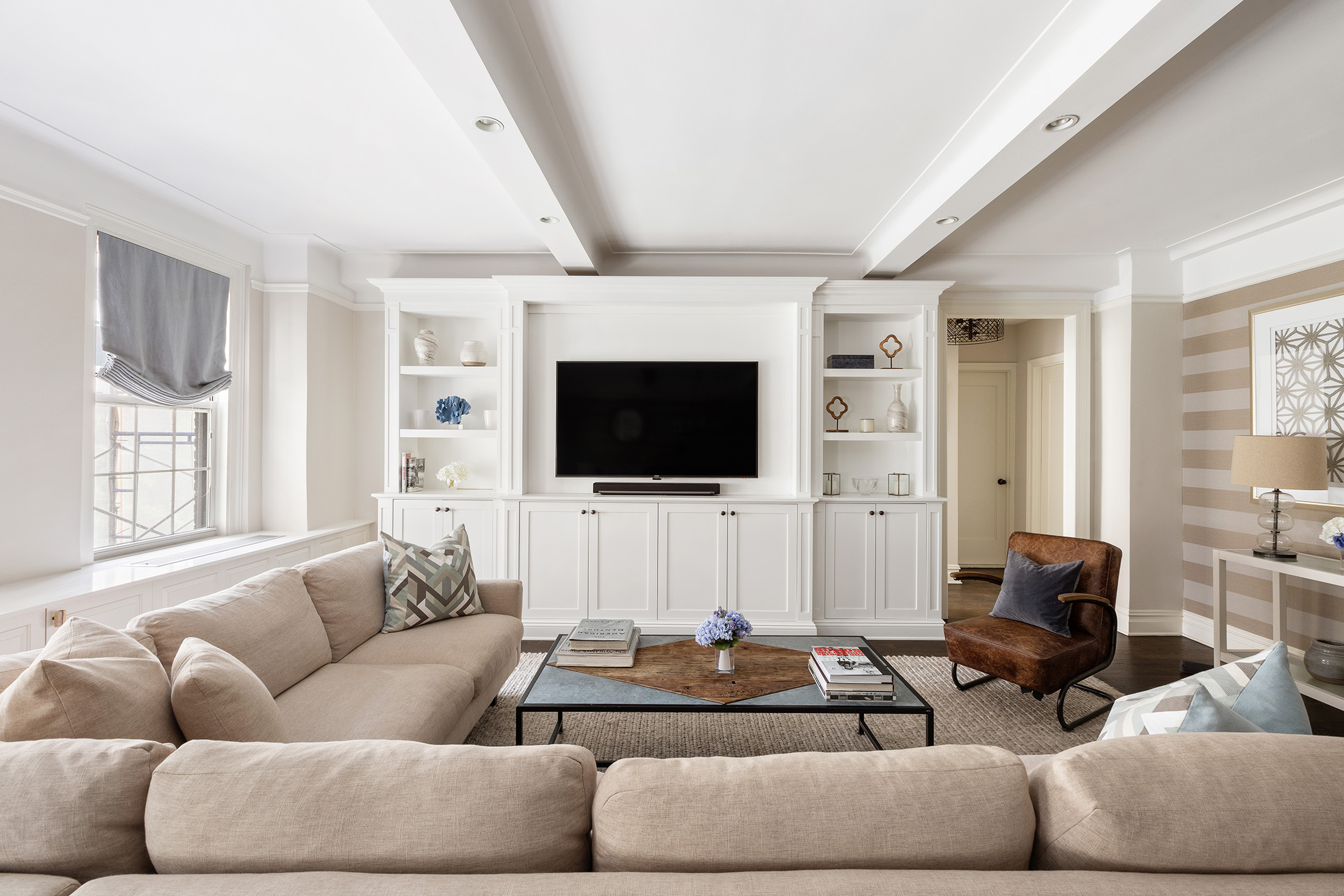 174 West 76th Street, Unit 4GH Manhattan, NY 10023 - Photo 2 of 16 a living room with furniture and a flat screen tv