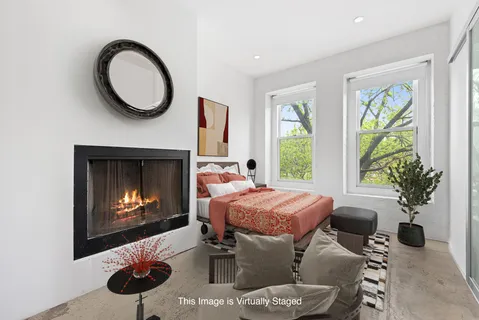 a living room with furniture a window and a fireplace