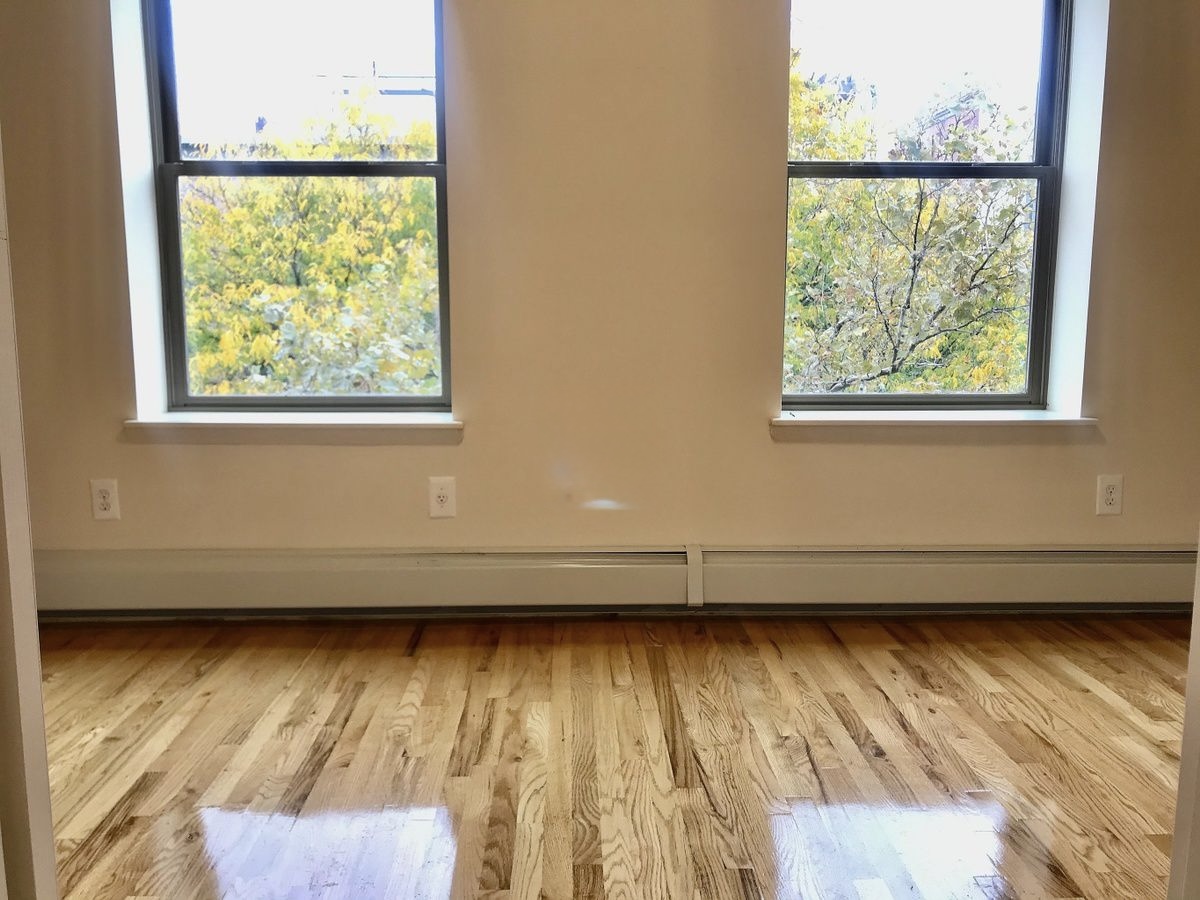 Convent Avenue Manhattan, NY 10031 - Photo 4 of 12 a view of a room with wooden floor and a window