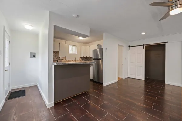 a kitchen with stainless steel appliances a refrigerator and a cabinets