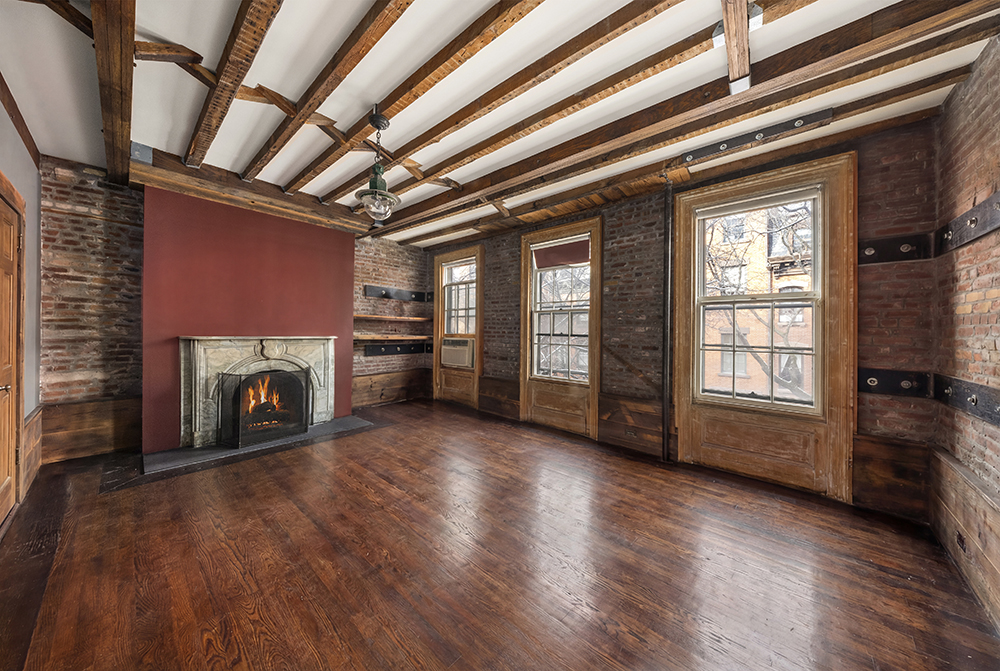 262 West 11th Street Manhattan, NY 10014 - Photo 10 of 27 a view of an empty room with wooden floor fireplace and a window