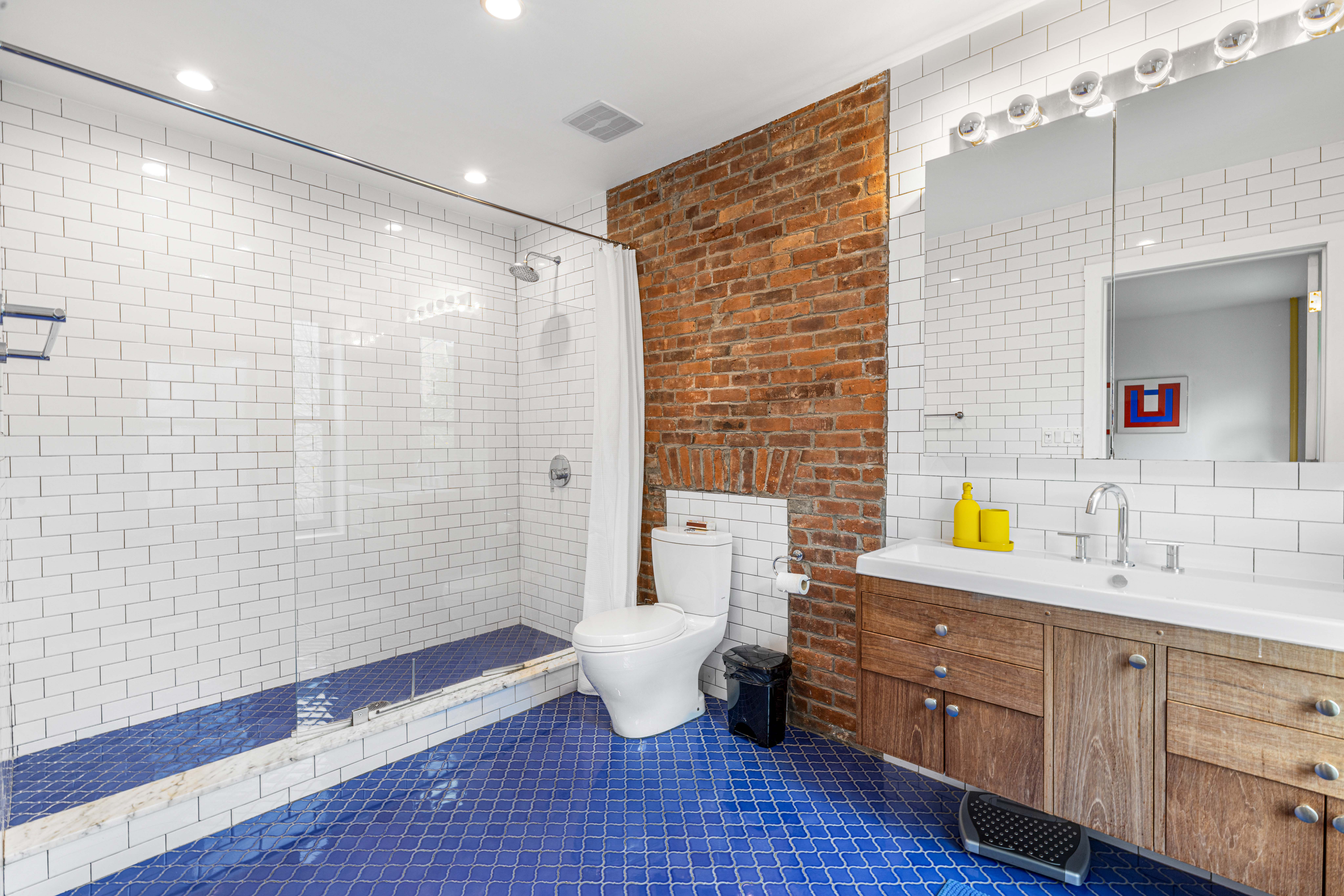 209 Calyer Street, Unit 2 Brooklyn, NY 11222 - Photo 16 of 17 a bathroom with a sink mirror toilet and shower