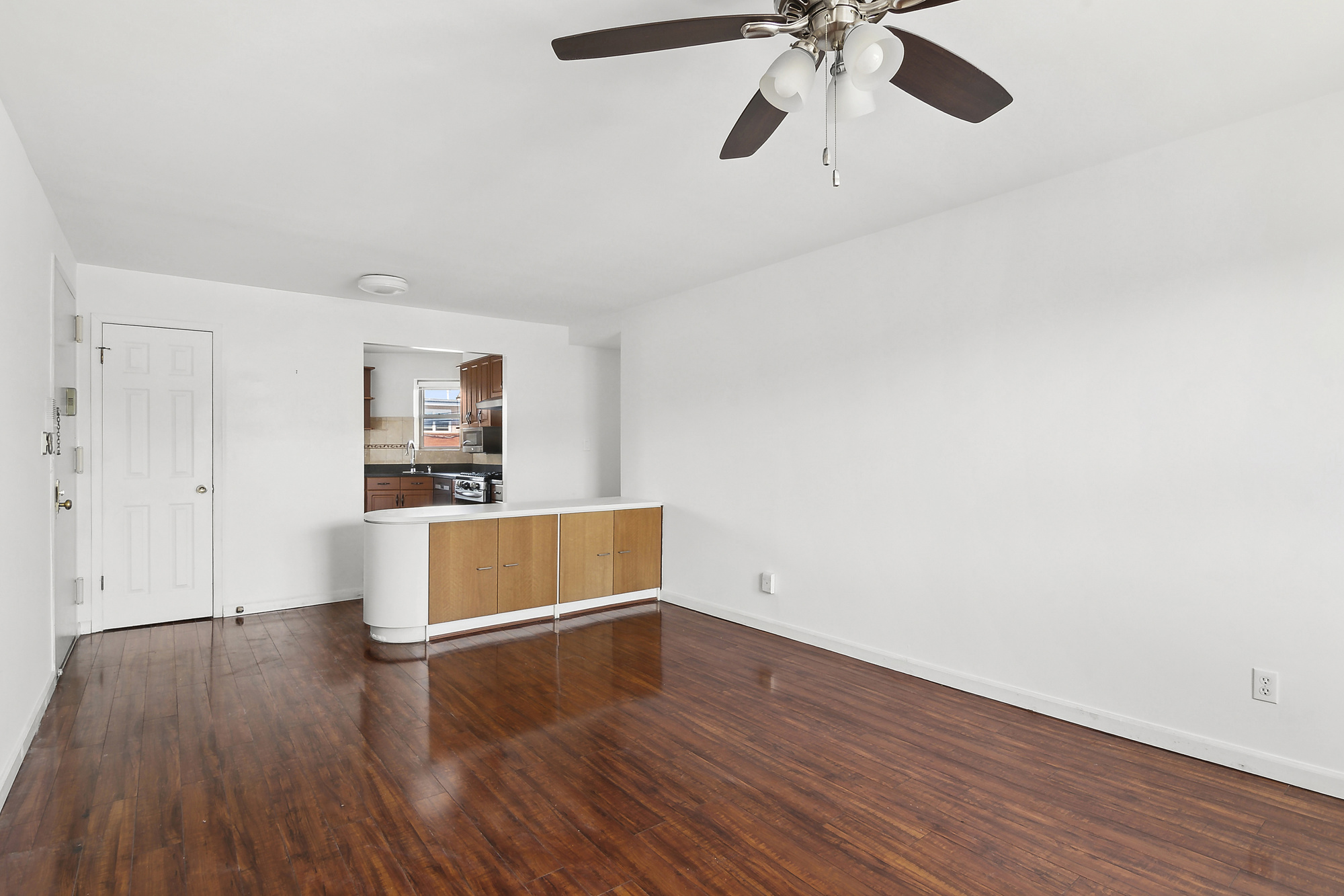 21-08 Butler Avenue, Unit J2 Queens, NY 11385 - Photo 9 of 14 a room with wooden floor and ceiling fan
