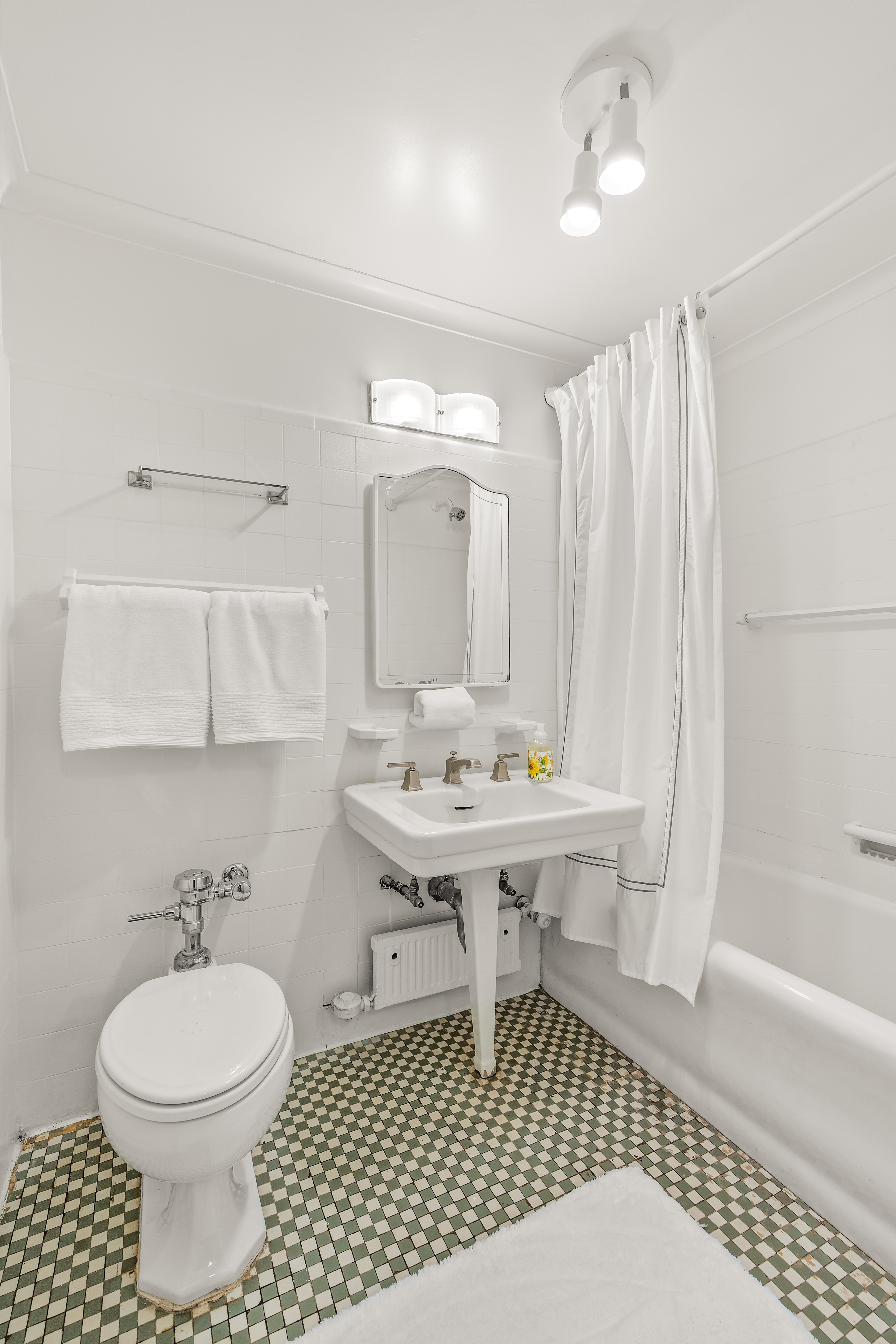 115 Central Park West, Unit 16H Manhattan, NY 10023 - Photo 20 of 30 a bathroom with a sink a toilet and shower