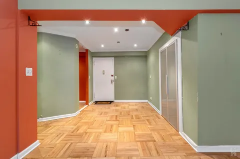 a large kitchen with stainless steel appliances a refrigerator and a stove top oven