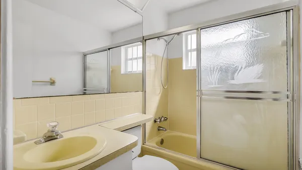 a bathroom with a sink mirror toilet and bathtub