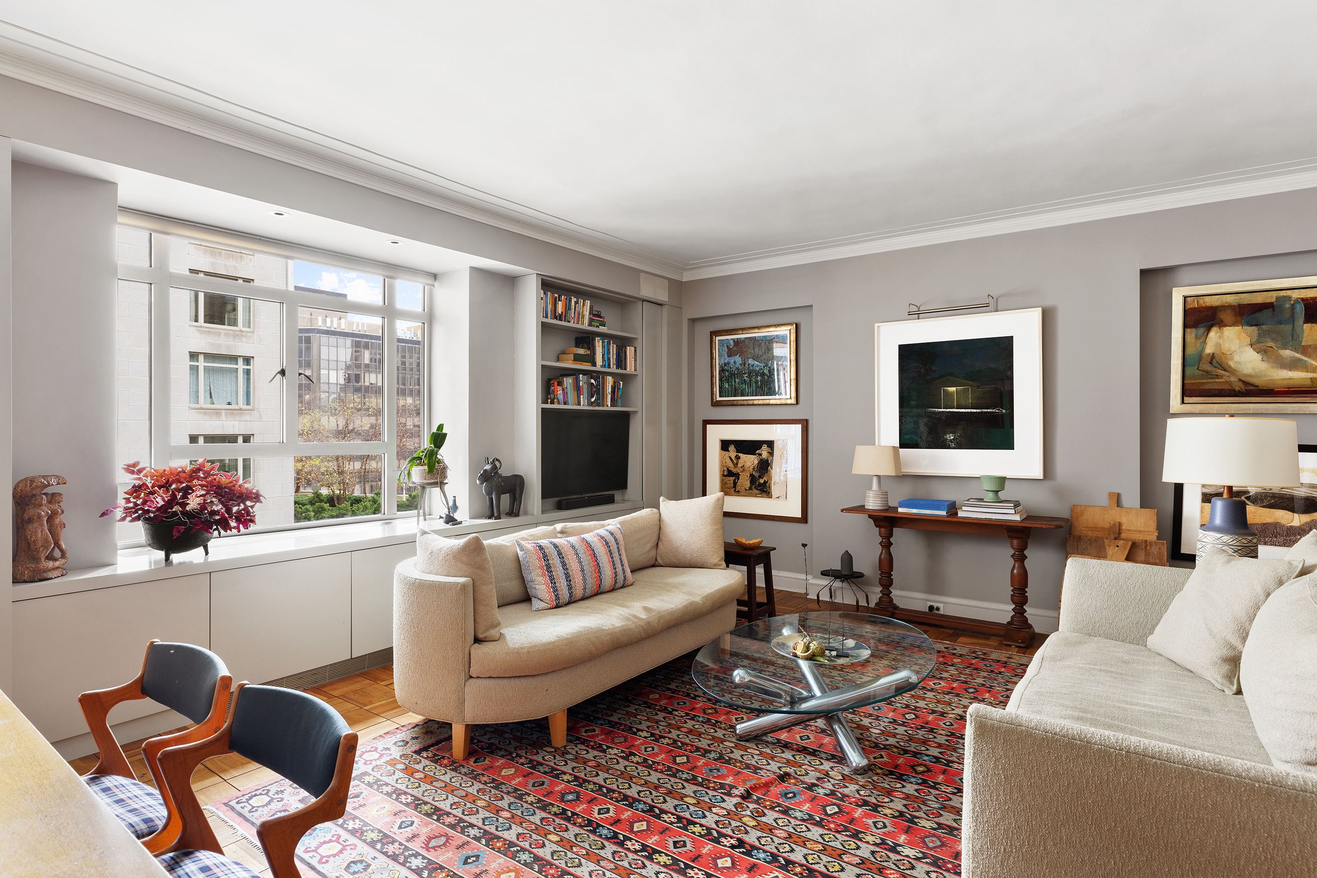 25 Central Park West, Unit 11C Manhattan, NY 10023 - Photo 1 of 17 a living room with furniture and a large window