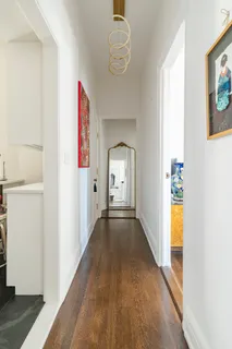 a view of hallway with wooden floor