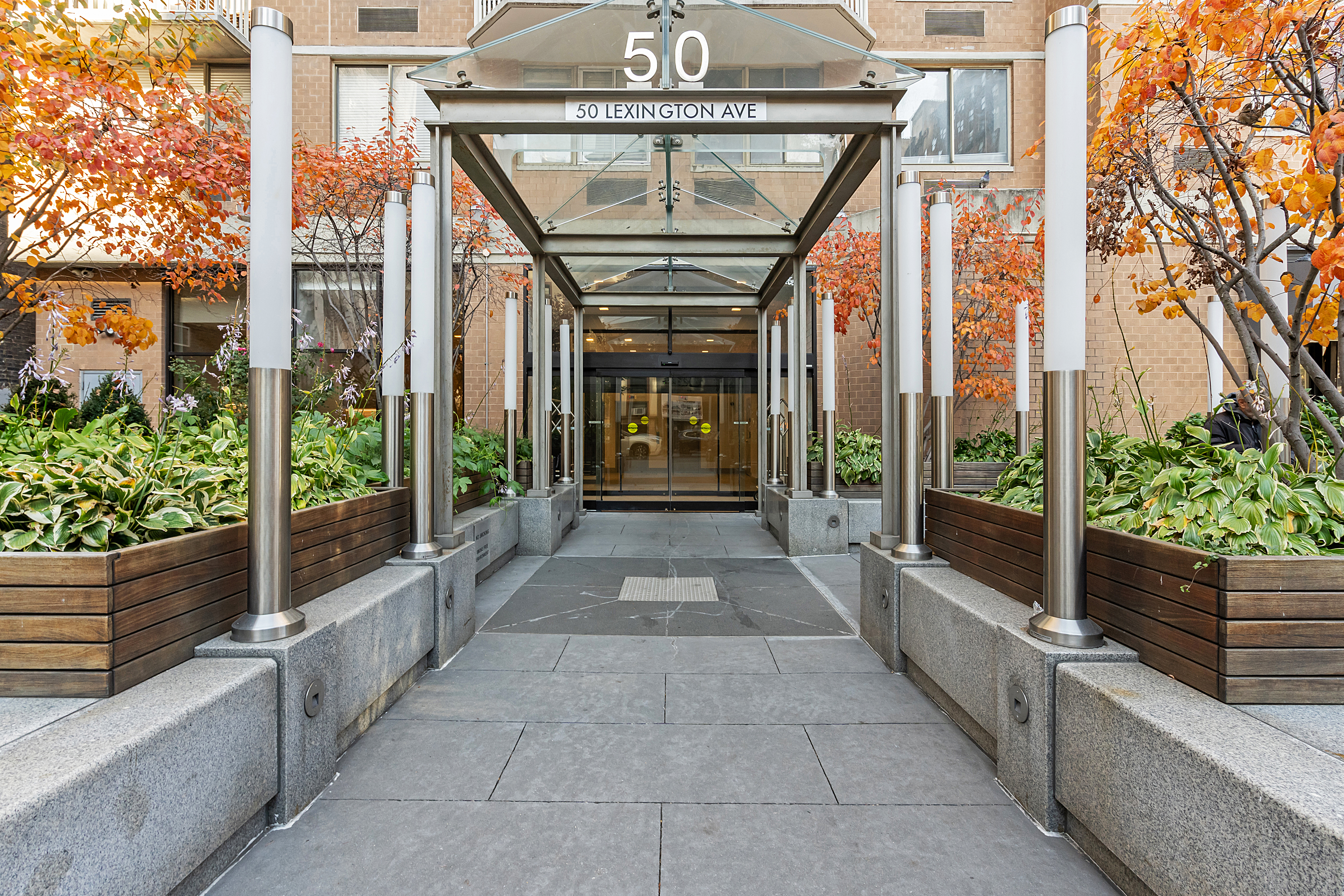 50 Lexington Avenue, Unit 18D Manhattan, NY 10010 - Photo 10 of 12 a view of entrance gate of the house with a large window and potted plants