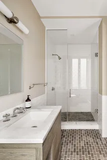 a bathroom with a sink a double vanity and a shower