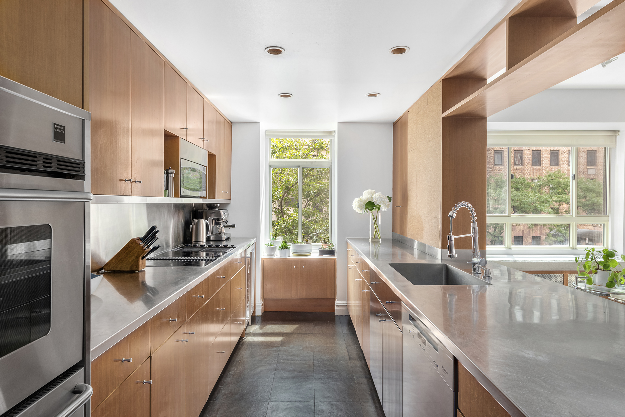 411 West End Avenue, Unit 3B/4B Manhattan, NY 10024 - Photo 5 of 16 a kitchen with stainless steel appliances granite countertop a sink a stove and a refrigerator