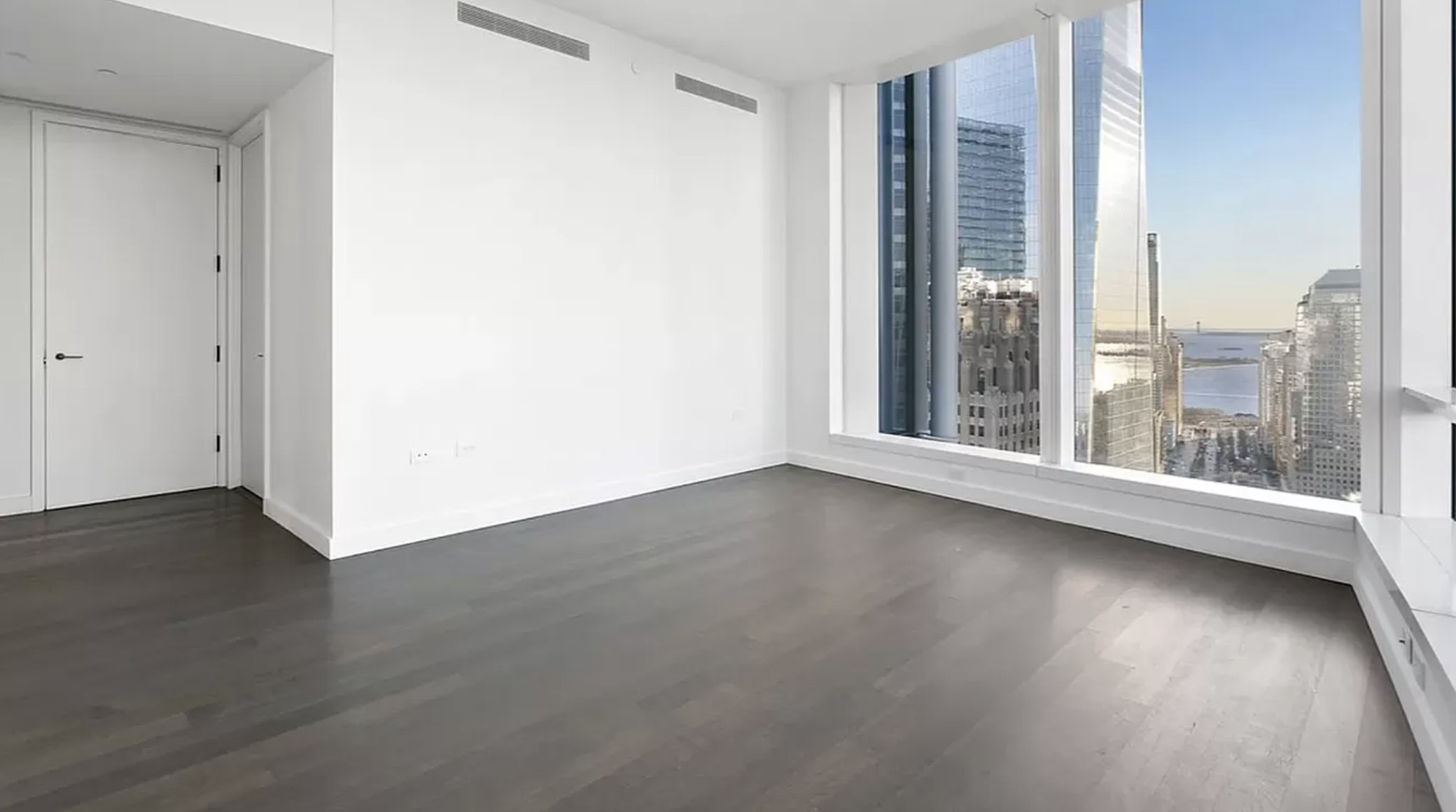 111 Murray Street, Unit 43W Manhattan, NY 10007 - Photo 2 of 32 an empty room with wooden floor and windows