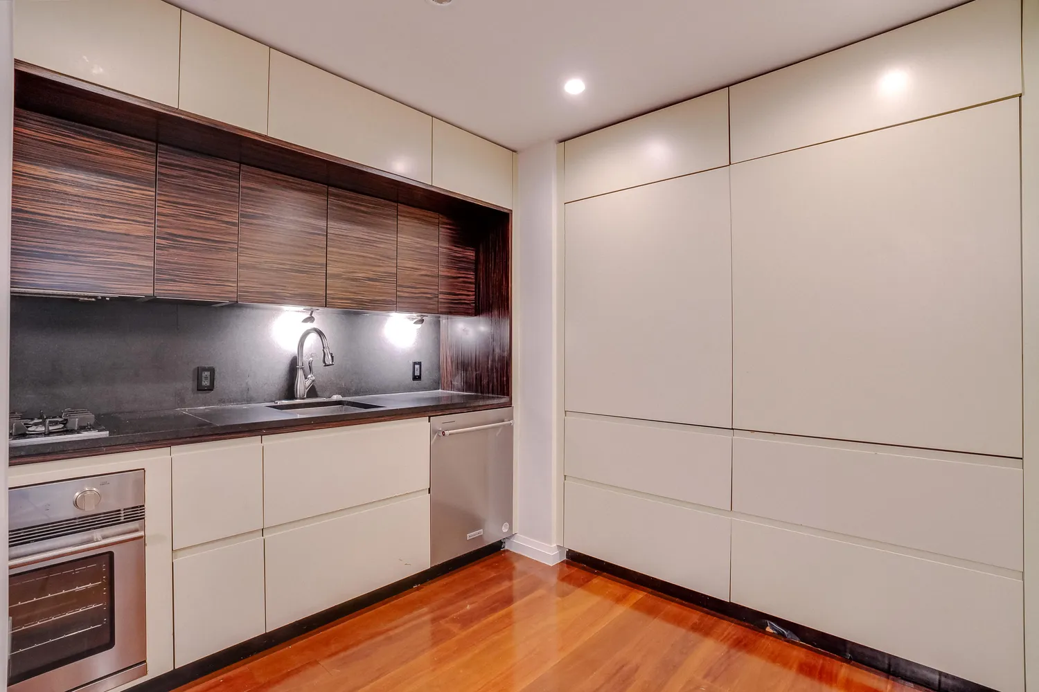 a kitchen with stainless steel appliances granite countertop a sink and a refrigerator