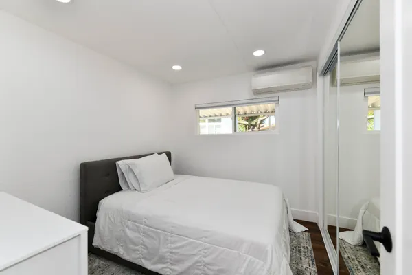 a bedroom with a bed and a window