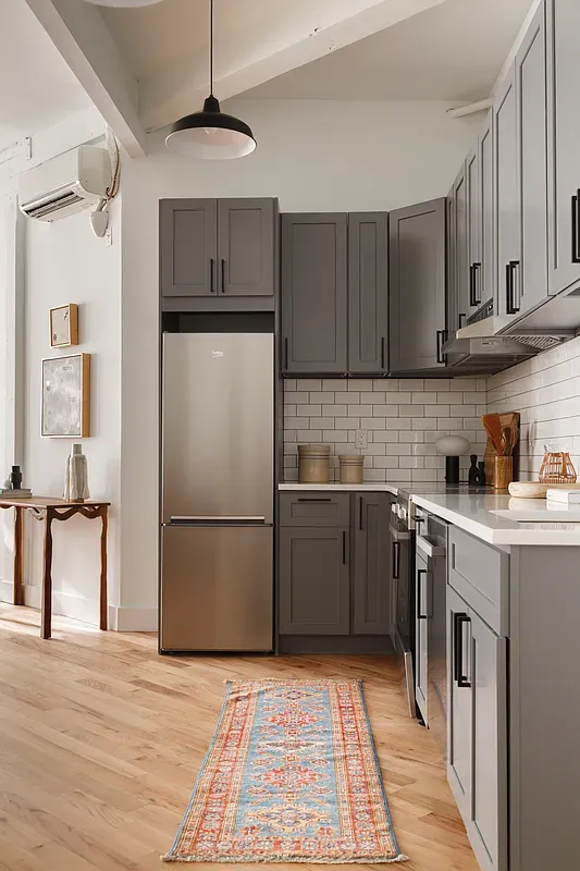 a kitchen with a refrigerator sink and cabinets