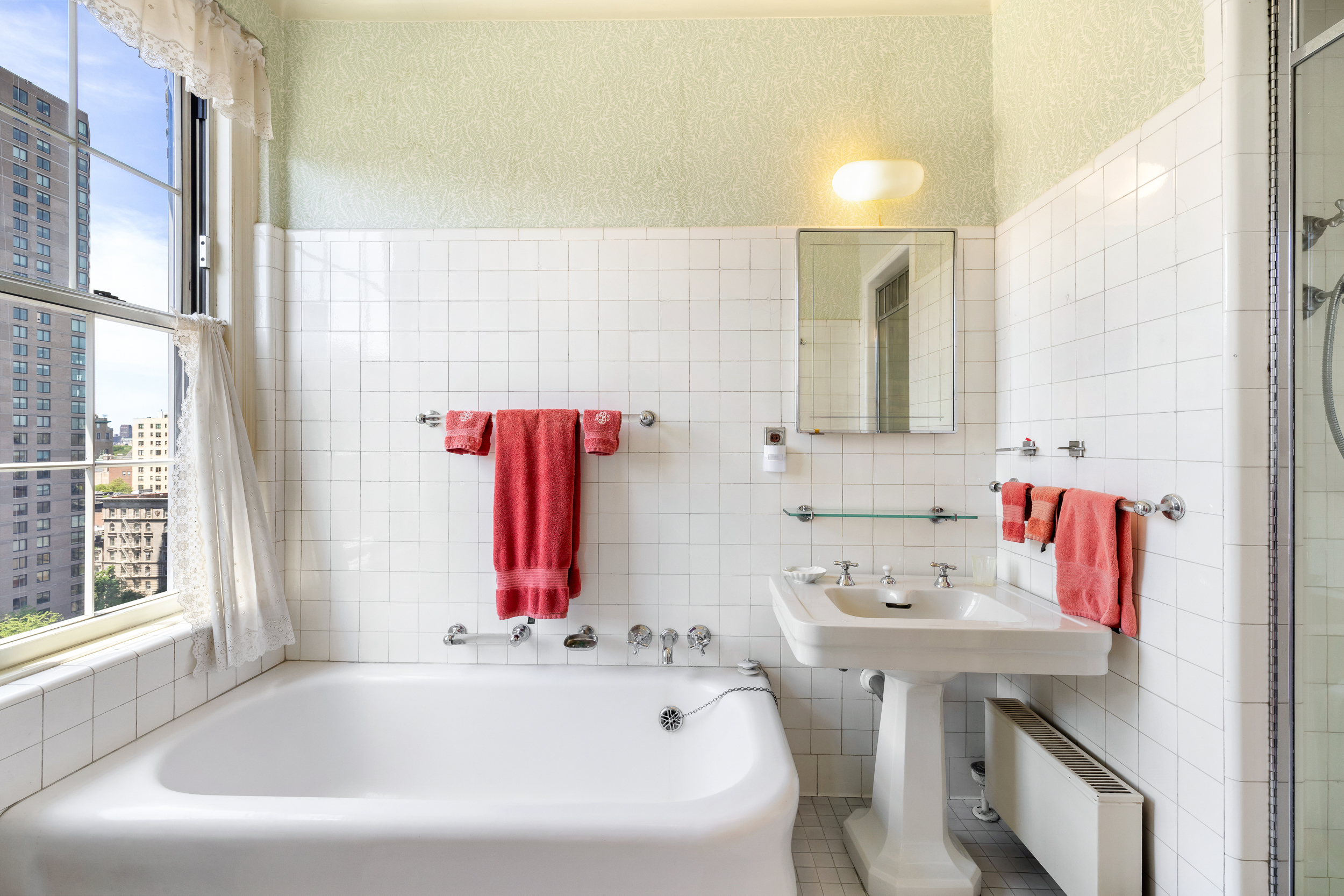 1220 Park Avenue, Unit 12B Manhattan, NY 10128 - Photo 10 of 12 a bathroom with a bathtub and a sink
