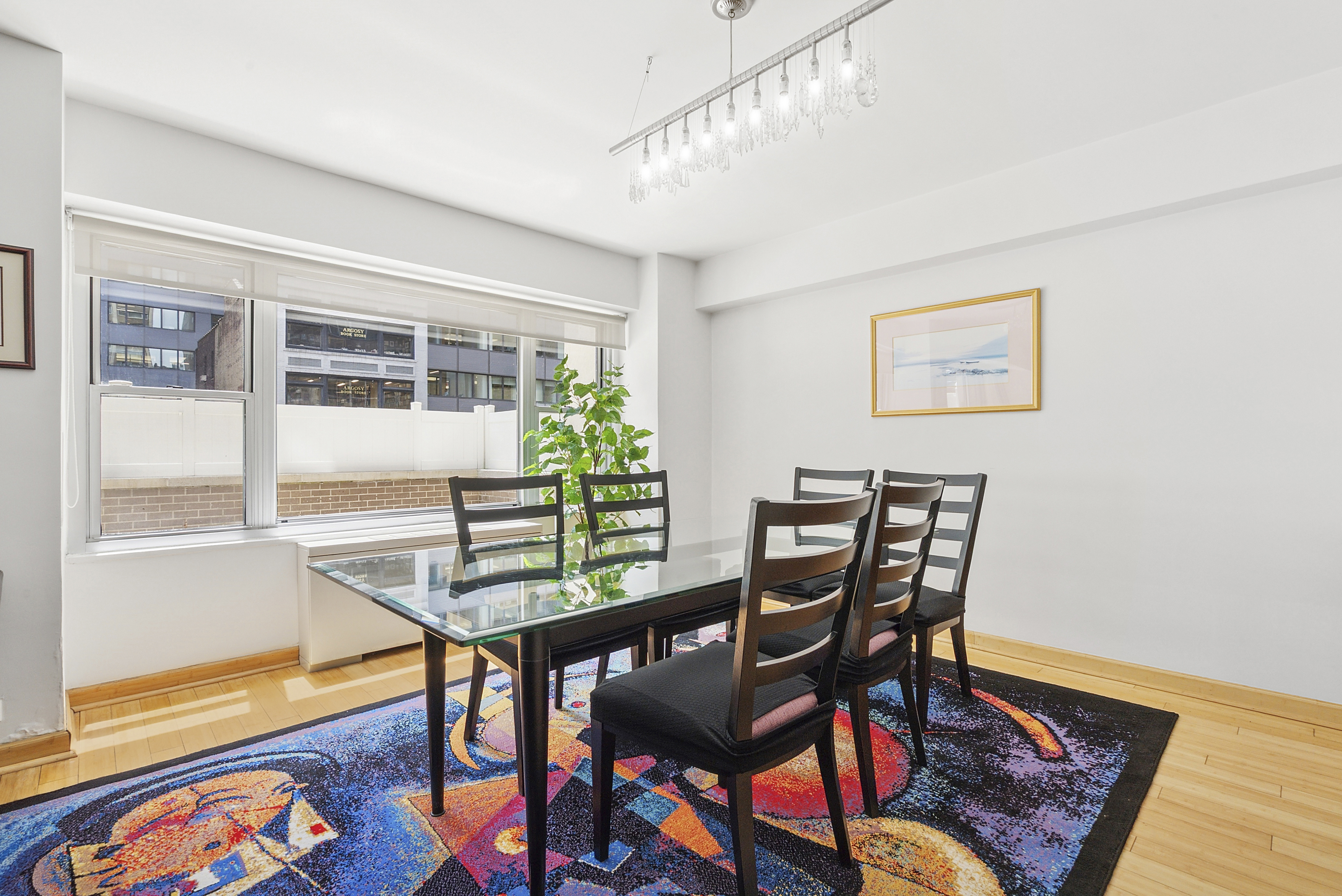 118 East 60th Street, Unit 4H Manhattan, NY 10022 - Photo 3 of 10 a view of a dining room with furniture and wooden floor