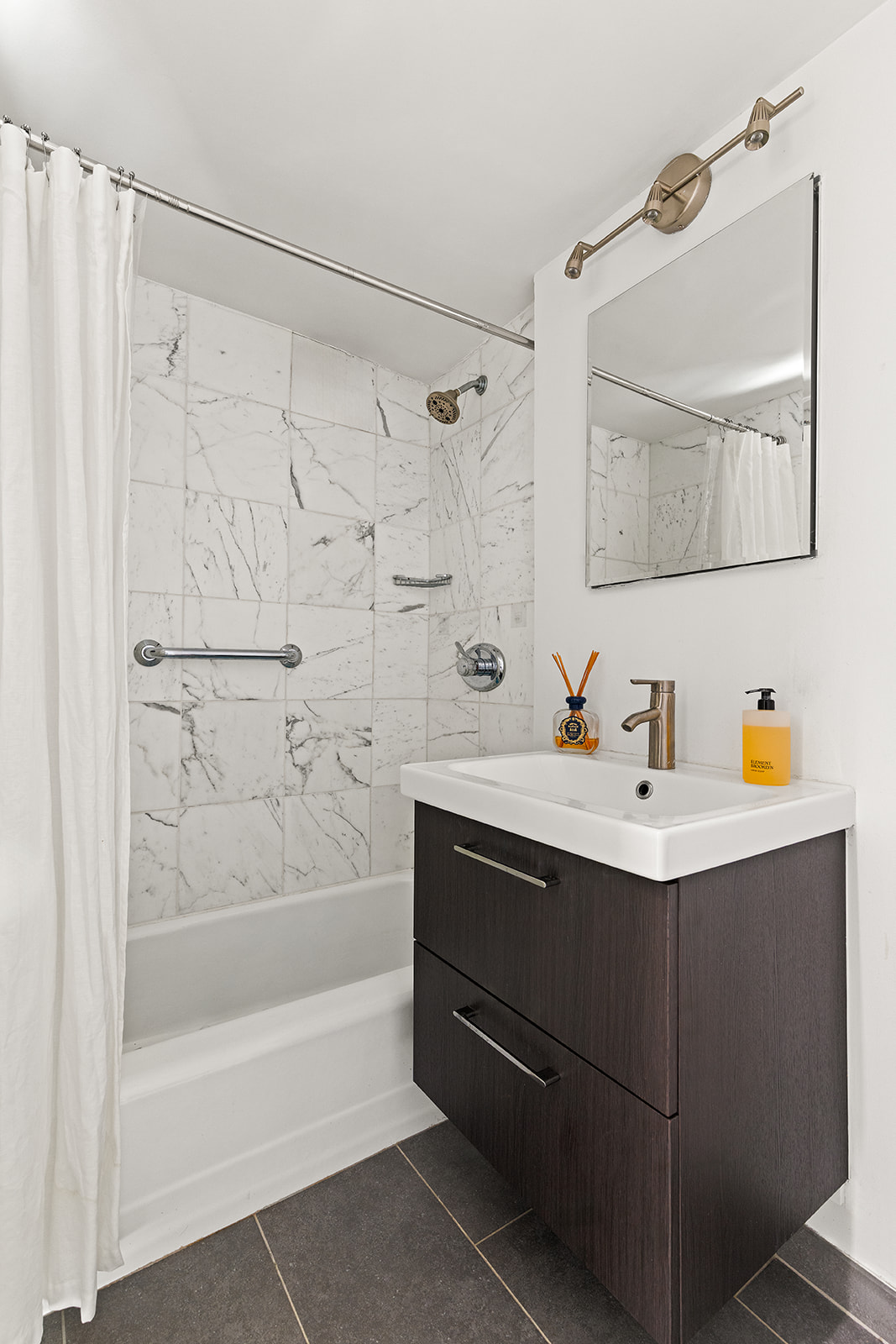401 East 65th Street, Unit 11HI Manhattan, NY 10065 - Photo 5 of 10 a bathroom with a sink mirror toilet and bathtub