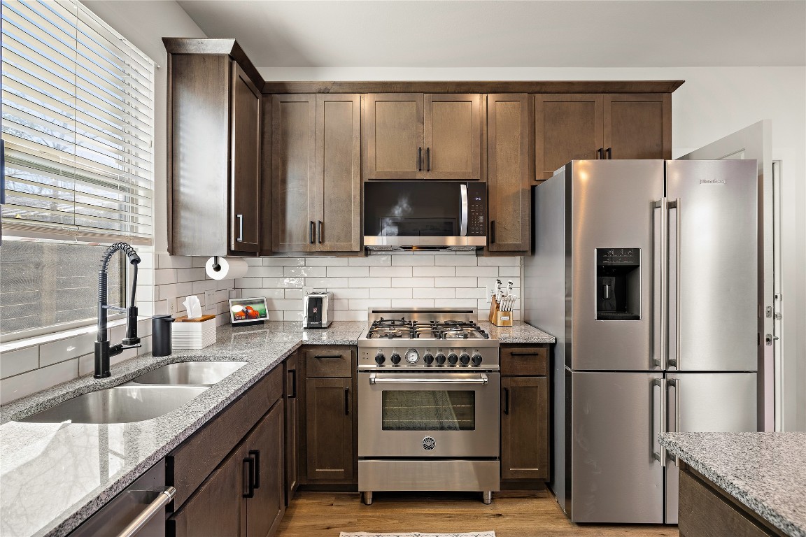 1402 Singleton Avenue, Unit B Austin, TX 78702 - Photo 7 of 26 a kitchen with a refrigerator stove and sink