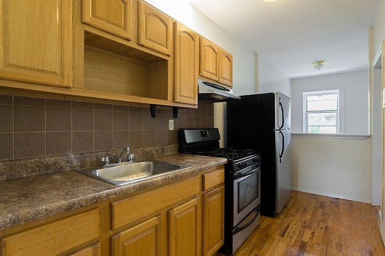 224 Cumberland Street, Unit 4 Brooklyn, NY 11205 - Photo 2 of 5 a kitchen with stainless steel appliances granite countertop a sink stove and refrigerator