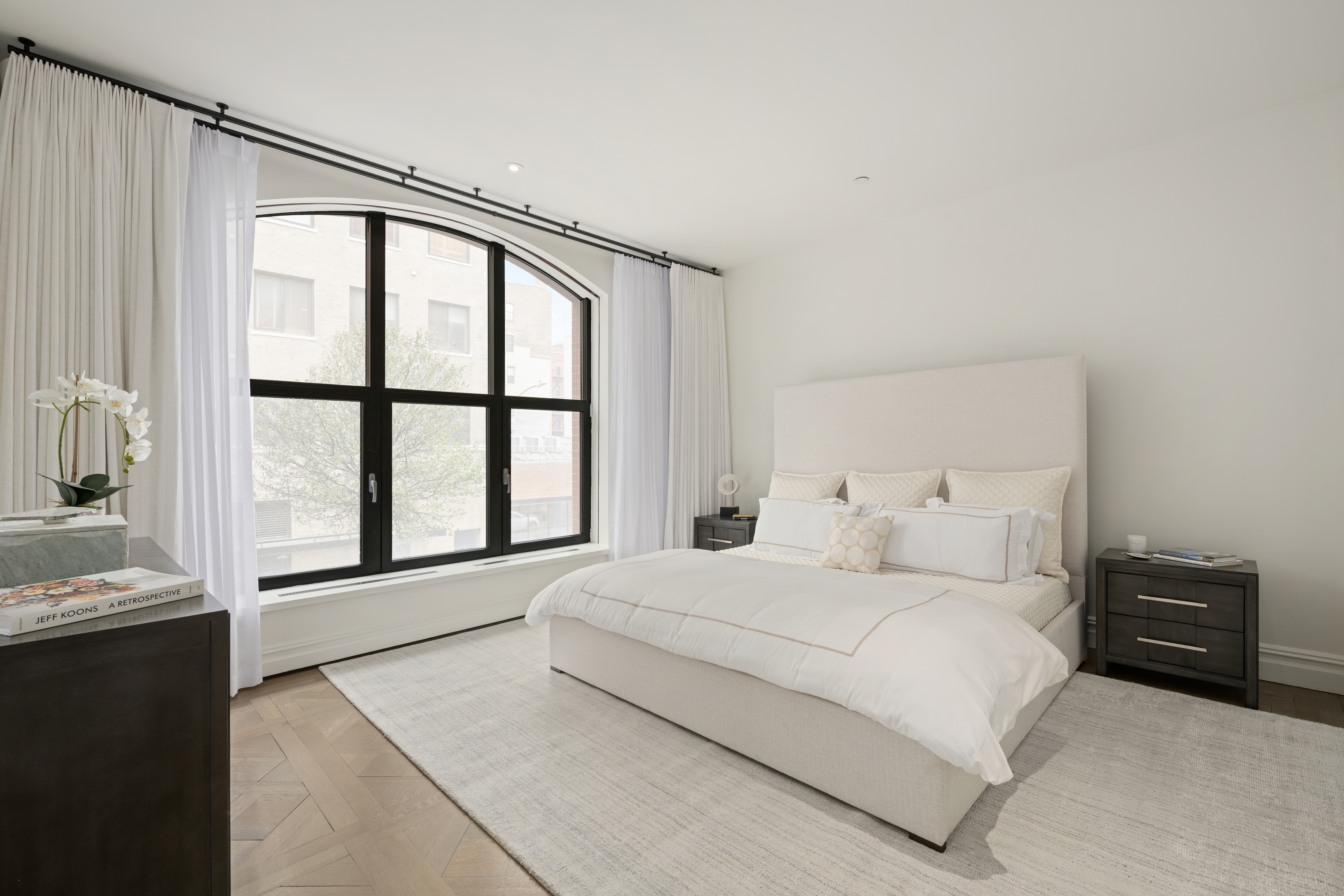 415 Washington Street, Unit 1B Manhattan, NY 10013 - Photo 5 of 16 a bedroom with a bed and a large window