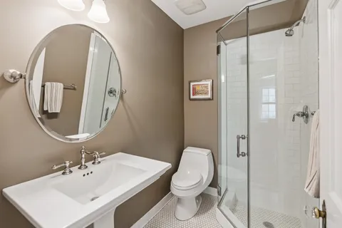 a bathroom with a toilet sink and shower
